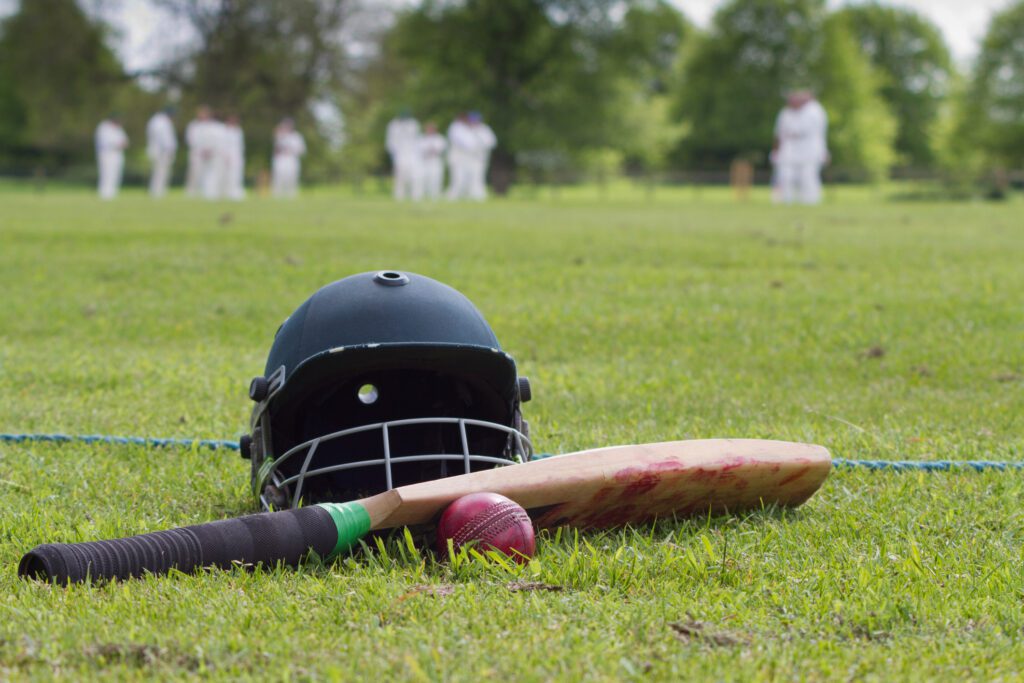 Cricket helmet, bat and ball